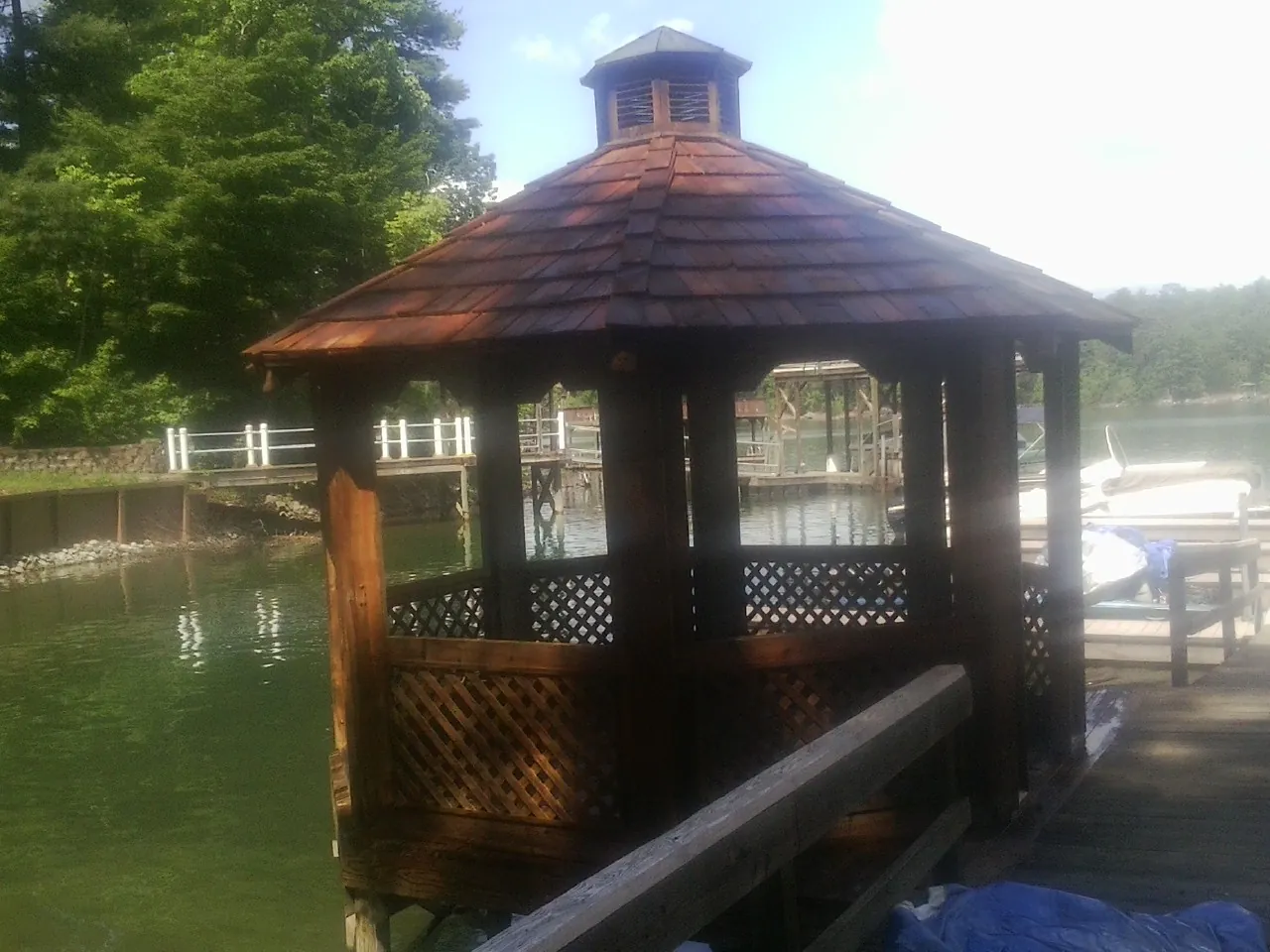 Cedar shake gazebo roof rebuilt on a lake dock in Jennings